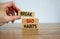 Break bad habits symbol. Wooden blocks with words `break bad habits`. Male hand. Beautiful wooden table, white background, copy