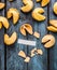 Break fortune cookie with blank paper tag on blue wooden background, top view