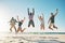 Break loose with your best friends. Shot of a group of young friends jumping enthusiastically in the air at the beach.