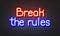 Break the rules neon sign on brick wall background.