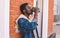 Break time! Fashion african man drinks coffee on city street