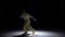 Breakdance dancer in yellow suit dance on black, shadow, slow motion