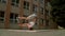 Breakdancer spins on his head on the street, slowmotion
