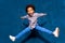 Breakdancing joyful african american cute little child boy levitating in jump.