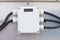 Breaker small power button white with black wire to distribute electricity supply with metal flex pipe.