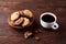 Breakfast background with mug of fresh coffee, homemade oatmeal cookies, grind coffee