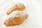 Breakfast bakery, croissant with powdered sugar and almond flakes on white background