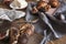 Breakfast with batter & bread, croissants, figs, silver spoons on wooden rustic background, warm colors, close-up.