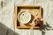 Breakfast in bed, tray with bowl muesli, granola and flower in sunlight at home