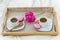 Breakfast in bed for two. Wooden tray with coffee, macaroons and Bizet.