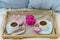 Breakfast in bed for two. Wooden tray with coffee, macaroons and Bizet.