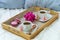 Breakfast in bed for two. Wooden tray with coffee, macaroons and Bizet.