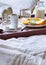 Breakfast in bed on wooden tray with fruits, milk, eggs and coffe. Window light, copy space