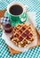 Breakfast with belgian waffles with jam and coffee