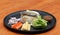 Breakfast in the black round plate. Fried mackerel and Rice with Spicy Shrimp Paste Dip and vegetable, Chinese cabbage, baby corn