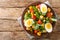 Breakfast of boiled eggs and salad of lupine beans, tomatoes and common cornsalad close-up in a plate. horizontal top view