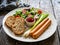 Breakfast - boiled sausages, bread and fresh vegetables served on wooden table