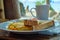 Breakfast on Boracay island of the Philippines with views of the white sandy beach and sea. An omelet and a Cup of coffee in a