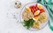 Breakfast bowl with oatmeal, sandwiches with chicken rillettes, tomato and boiled egg.