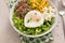 Breakfast bowl with quinoa, herbed corn, feta cheese and fried egg