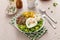 Breakfast bowl with quinoa, herbed corn, feta cheese and fried egg