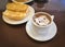 Breakfast at Brazil with french bread toasted with butter on the plate with capuccino on table