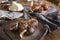 Breakfast with bread, croissants, figs, silver spoons on wooden rustic background, warm colors, close-up.