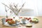 Breakfast or brunch with Easter egg decoration on a wooden dining table, place setting on a spring holiday, copy space, selected