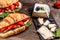 Breakfast, business lunch, sandwiches Croissant with strawberries and soft cheese with mold brie camembert on wooden background.