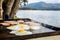 Breakfast camp cooking, Grilling eggs and bacon on the bbq plate with beautiful nature landscape on background