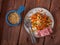 Breakfast with carrot salad with seeds and ham on a wooden tray