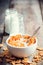 Breakfast cereal wheat flakes in ceramic bowl and milk bottles o