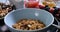 Breakfast cereals falling on a bowl with berries and dry fruits