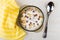 Breakfast cereals in form stars with yogurt in bowl, spoon