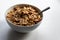 Breakfast cereals with healthy cornflakes and delicious walnuts and honey in a bowl are the perfect start in the day