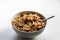 Breakfast cereals with healthy cornflakes and delicious walnuts and honey in a bowl are the perfect start in the day