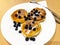 Breakfast for child. Delicious sweet pancakes with syrup, blueberries