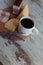 Breakfast, coffee, cheese and meat on a wooden stand on the table.