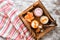 Breakfast, a collection of yogurt blueberry, tangerine, spoons, striped napkin on a wooden tray. Copy space, top view.