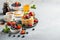 Breakfast composition with fresh pancakes and berries on light gray concrete background. Healthy food concept with copy space.