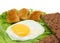 Breakfast copy space: fried egg, lettuce, crisp bread and nugget