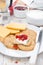 Breakfast with crackers, cheese, cream and berry jam, close-up