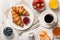 Breakfast with croissants, coffee jams and berries