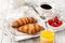 Breakfast with croissants, coffee, orange juice and strawb