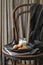 Breakfast with croissants and milk served on an old chair in the bedroom