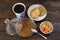 Breakfast. A cup of coffee, cookies, candied fruits and jam on a wooden table