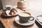 Breakfast, cups of coffee and fresh croissant on a table in a coffee shop