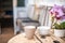 Breakfast, cups on the table in the garden. Textural old vintage table in rustic style and orchid. Potted flowers in a greenhouse