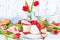 Breakfast or a dinner table with various delicacies for Easter meals. Fresh strawberries and currants with soft cheese and red