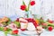 Breakfast or a dinner table with various delicacies for Easter meals. Fresh strawberries and currants with soft cheese and red